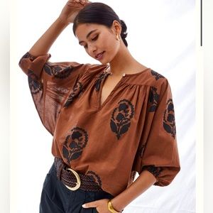 Anthropologie brand Omika Brown and black top. Key hole button. Size Large